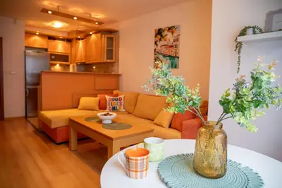 a living room with a couch and a table at Casita Central - FREE Private Parking & Metro station in Sofia