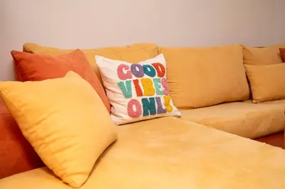 a couch with some pillows on top of it at Casita Central - FREE Private Parking & Metro station in Sofia