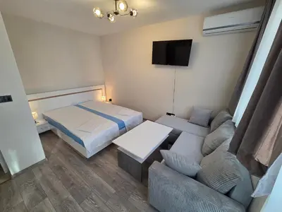 a small room with a bed and a couch at Paradise Studio NBU in Sofia