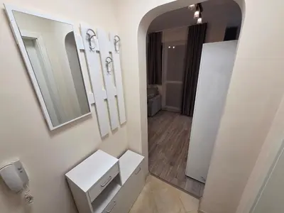 a bathroom with a mirror and a white sink at Paradise Studio NBU in Sofia