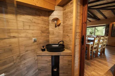 a room with wooden walls and a black pot on a table at Abies Alba in Yarema residence zone