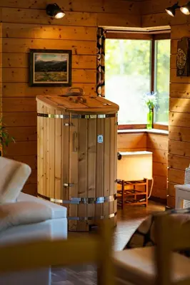 a wooden cabin with a hot tub in a room at Abies Alba in Yarema residence zone