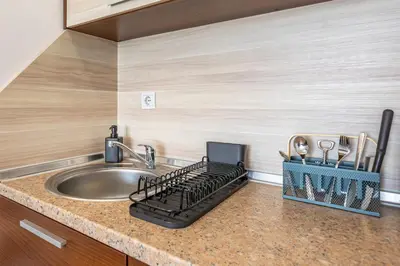a kitchen counter with a sink and a stove at Alpine Escape Bansko in Bansko