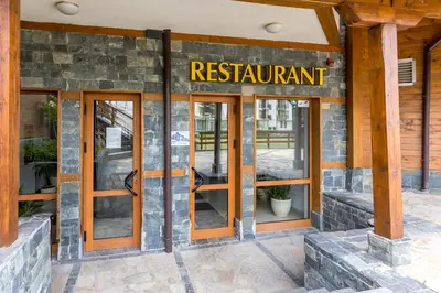 a restaurant with glass doors and a sign that reads restaurant at Alpine Escape Bansko in Bansko