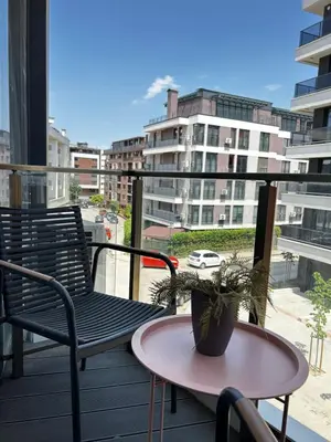 a balcony with two chairs and a table with a plant at Rea Liliya - Artistic and Inviting Nook in Sofia