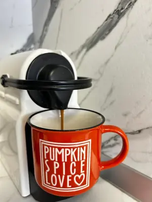 a cup of coffee with a spoon in it at Rea Silena - Modern and Stylish Studio in Sofia