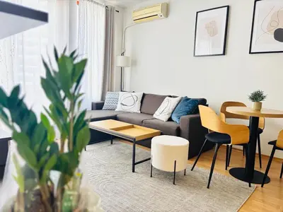 a living room with a couch and a table at Guest House Amaya by novotela in Plovdiv