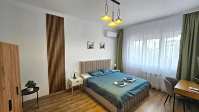 a bedroom with a bed with blue pillows in it at Stylish 2-Bedroom Apartment in Top Center - 5m walk to Metro station Serdika, Sofia statue -- 1 FullBath & 1Washroom in Sofia
