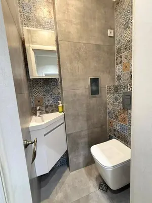 a small bathroom with a toilet and a sink at Stylish 2-Bedroom Apartment in Top Center - 5m walk to Metro station Serdika, Sofia statue -- 1 FullBath & 1Washroom in Sofia