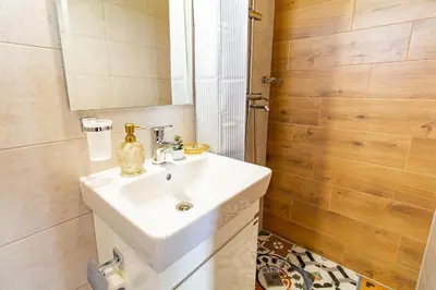 a bathroom with a white sink and a mirror at Дедовата Къща in Dedovo