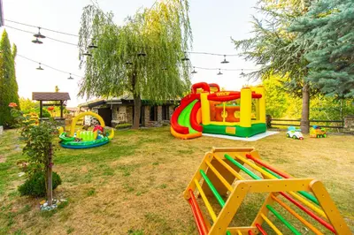 a backyard with a playground with a play equipment at Дедовата Къща in Dedovo