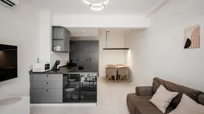 a living room with a couch and a kitchen at Cosy & Modern 1BD Flat close to NDK by Flat Mаnager in Sofia