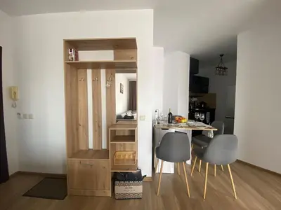 a small kitchen with a table and chairs in a room at Barosa Apartment Bansko Royal Towers in Bansko