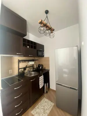 a kitchen with a sink and a refrigerator at Barosa Apartment Bansko Royal Towers in Bansko
