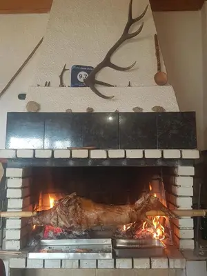 a turkey is cooking in a brick fireplace at Guest House Chala in Chala