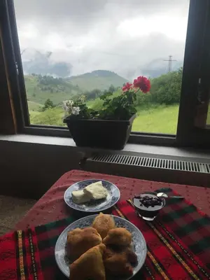 two plates of food on a table with a window at Guest House Chala in Chala