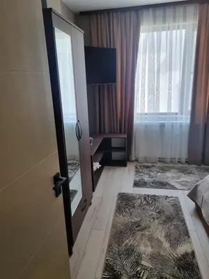 a hotel room with a door and a window at Apartament Rumqncev in Velingrad