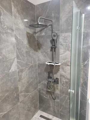 a shower with a glass door in a bathroom at Apartament Rumqncev in Velingrad