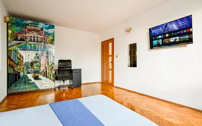 a bedroom with a bed and a tv on the wall at Spacious 3BR in the Center - Kitchen Smart TV's in Sofia