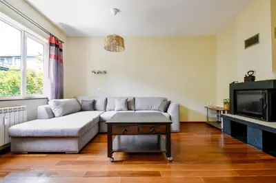a living room with a couch and a tv at Modern 2BD Flat in Central Sofia with Workspace by Flat Mаnager in Sofia