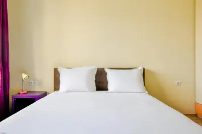 a bedroom with a large bed with two white pillows at Modern 2BD Flat in Central Sofia with Workspace by Flat Mаnager in Sofia