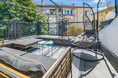a balcony with a hammock and swings on a building at Charming Downtown Apartment with Unique Terrace in Sofia