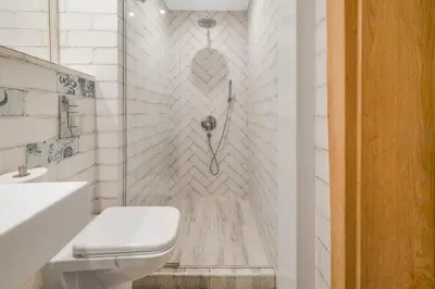 a white bathroom with a toilet and a shower at Charming Downtown Apartment with Unique Terrace in Sofia