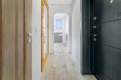a hallway with a door and a mirror at Charming Downtown Apartment with Unique Terrace in Sofia