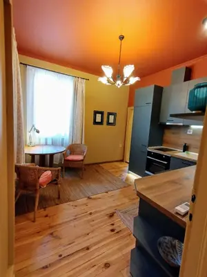 a kitchen and living room with a table and a window at Moon House Red in Plovdiv
