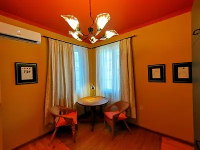 a dining room with a table and chairs and a chandelier at Moon House Red in Plovdiv