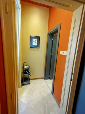 an empty hallway with orange walls and a doorway at Moon House Red in Plovdiv