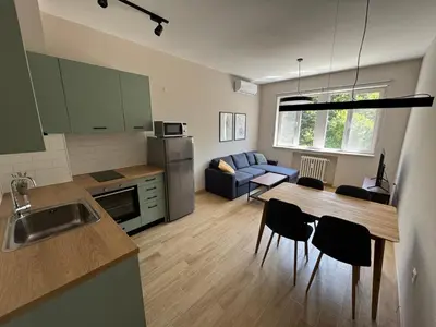 a kitchen and living room with a table and chairs at By The River in Plovdiv