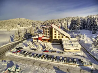 an aerial view of a hotel in the snow at Hotel Coop Rozhen in Pamporovo