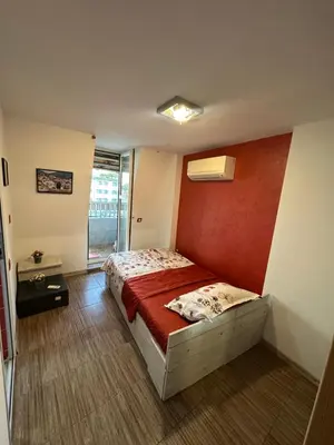 a bedroom with a bed with a red wall at Guest Rooms Comfort 2 in Plovdiv
