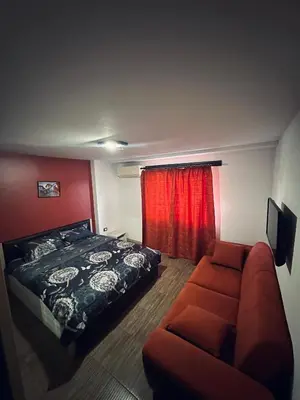 a bedroom with a bed and a couch at Guest Rooms Comfort 2 in Plovdiv