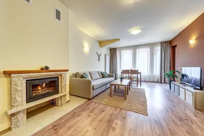 a living room with a couch and a fireplace at Cosy1BD Apt with a Free Parking and Balcony - Grand Resort Pamporovo by Flat Manаger in Pamporovo