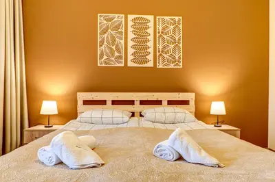 a bedroom with a bed with two towels on it at Cosy1BD Apt with a Free Parking and Balcony - Grand Resort Pamporovo by Flat Manаger in Pamporovo