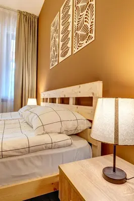 two beds in a bedroom with a lamp and a table at Cosy1BD Apt with a Free Parking and Balcony - Grand Resort Pamporovo by Flat Manаger in Pamporovo