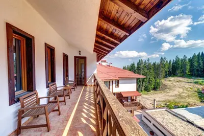 a balcony of a house with chairs on it at Cosy1BD Apt with a Free Parking and Balcony - Grand Resort Pamporovo by Flat Manаger in Pamporovo