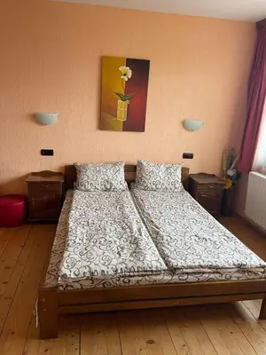 a large bed in a bedroom with at Къща за гости Лясково in Lyaskovo