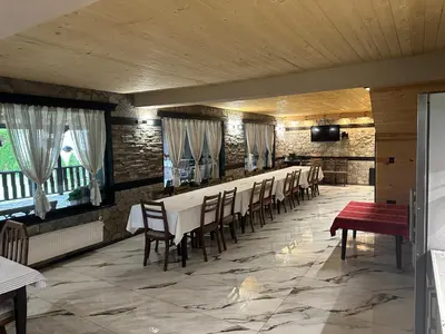 a dining room with a long table and chairs at Къща за гости Лясково in Lyaskovo