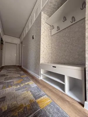 a living room with a white table and a rug at Нощувки 