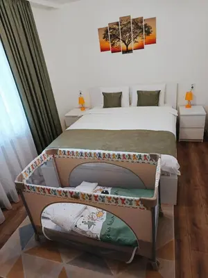 a bedroom with a bed and a bed frame at Нощувки 