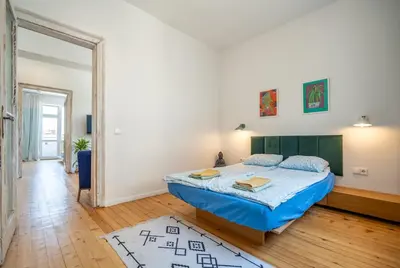 a bedroom with a bed with a blue comforter at Bright & Central 2BR in Historic Heart of Sofia in Sofia