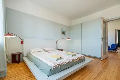 a bedroom with a bed with two books on it at Bright & Central 2BR in Historic Heart of Sofia in Sofia