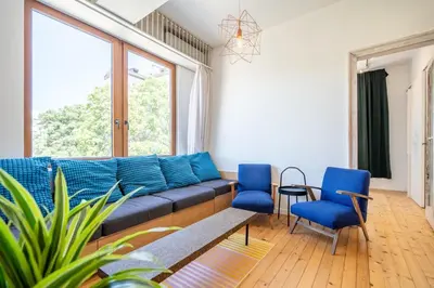 a living room with a blue couch and blue chairs at Bright & Central 2BR in Historic Heart of Sofia in Sofia