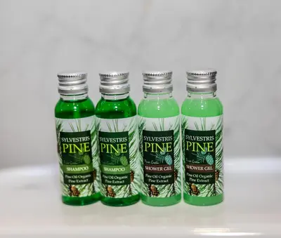 a group of four bottles of pineapple juice at Alpine Escape Design apartment Detelina Residence in Bansko