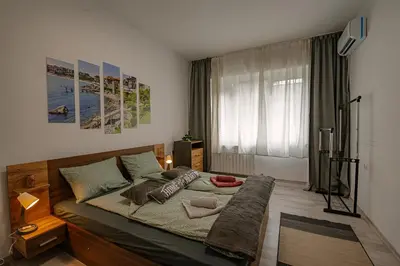 a bedroom with a large bed in a room at Two Luxury Condos by NDK and National Stadium with 2 Free Parking Spots in Sofia