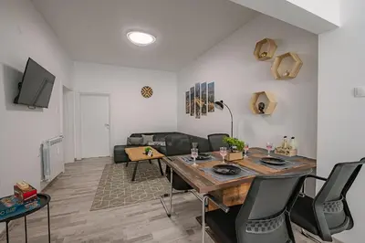 a living room with a table and a couch at Two Luxury Condos by NDK and National Stadium with 2 Free Parking Spots in Sofia