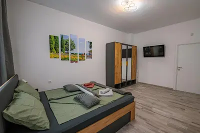 a bedroom with a bed and a television in it at Two Luxury Condos by NDK and National Stadium with 2 Free Parking Spots in Sofia